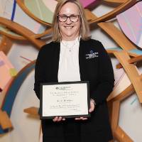 Sheri smiling with her award 2